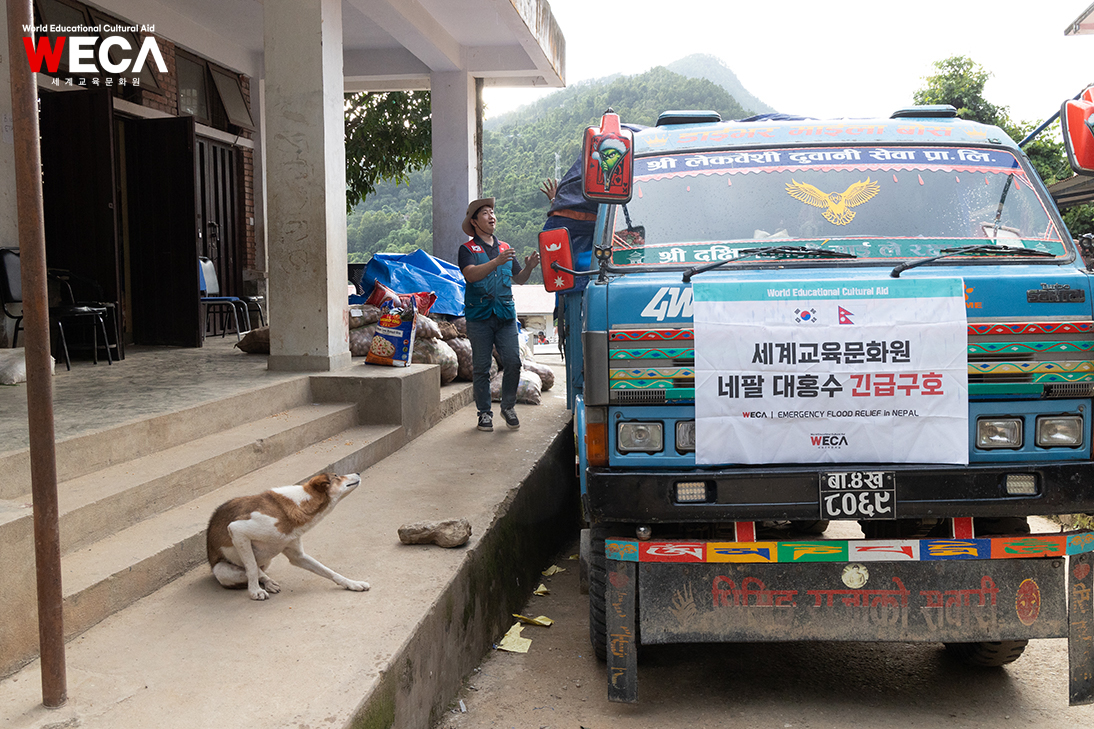 World Educational Cultural Aid WECA emergency relief truck loading emergency food items such as rice and cooking oil for flood victims in Rasuwa, Nepal